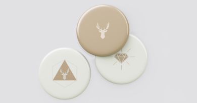 three white and beige badges